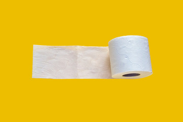 Roll of white toilet paper isolated on yellow background.