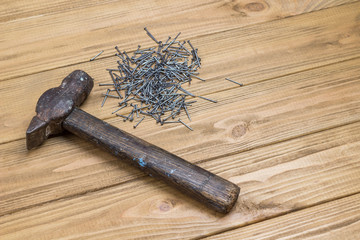 Old and dusty hammer and nails.