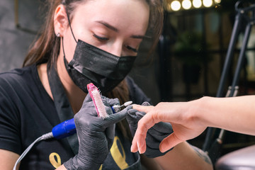 Close-up of hardware milling cutter for removing gel polish. Apparatus manicure in beauty salon....