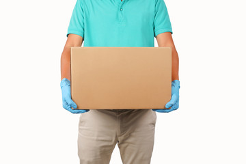 Delivery man wearing green shirts holding cardboard boxes on his side in medical rubber gloves. Online shopping and Express delivery concept.