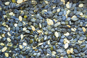 Peeled oval dark pumpkin seeds macro . Food preparation . Gluten free