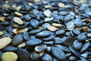 Peeled oval dark pumpkin seeds macro . Food preparation . Gluten free