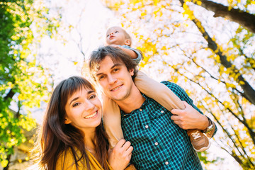 Low angle portrait of happy family together, father, mother and little son