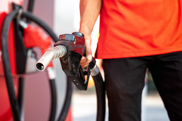 Close-up hands refueling in car,The petrol station staff is refilling the car for customers,Refill fuel in car at gas station,Focus hands refilling.