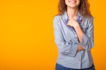 Close-up portrait pretty cool girl having fun over colorful yellow background. Copy space.