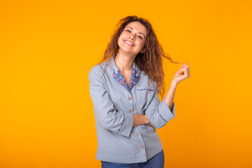 Fashion portrait pretty cool girl having fun over colorful yellow background.