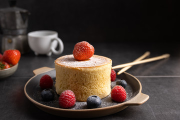 Trendy asian food, Fluffy homemade japanese souffle pancakes, hotcakes with raspberry, blackberry with copy space.