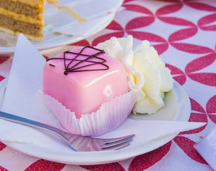 vanilla and chocolate cupcakes covered with strawberry icing and whipped cream
