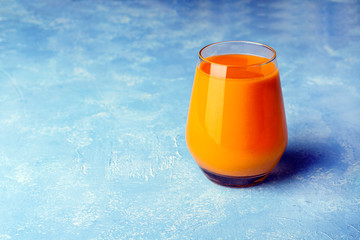 Nutritious detox carrot smoothie. Fresh organic vegetarian drink. Healthy eating concept. Proper nutrition, fitness diet concept. Orange juice in a glass. Copy space for text