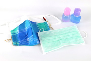 Sanitary mask with hand washing gel on a white background during the covid virus outbreak 19