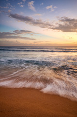Tropical beach at golden sunset, long exposure picture.