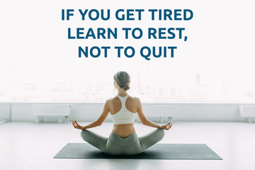 Fototapeta premium Sports motivation and success quotes, yoga classes. Athletic girl trains and stretches in the gym.