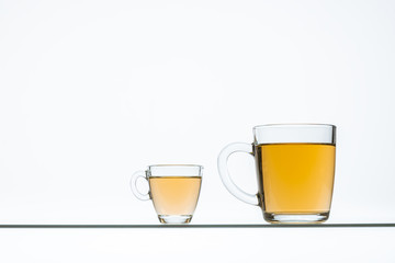 glass cups with hot tea on table, close view    