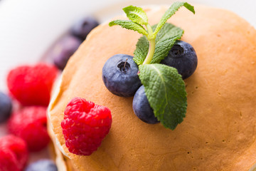 Homemade american pancakes with fresh blueberry and raspberries. Healthy morning breakfast. Rustic style