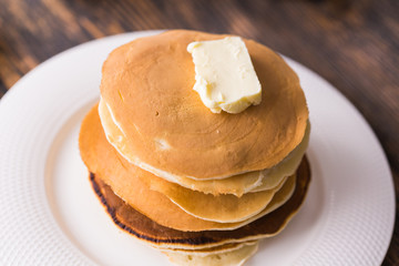 Pile of tasty pancakes with butter. Breakfast concept.