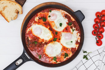 Delicious egg and tomatoo dish Shakshuka in iron skillet