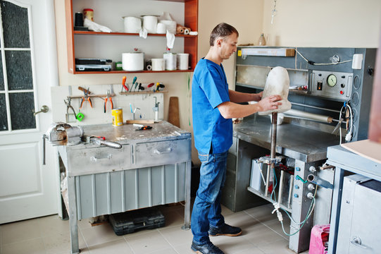 Prosthetist man making prosthetic leg while working in laboratory.