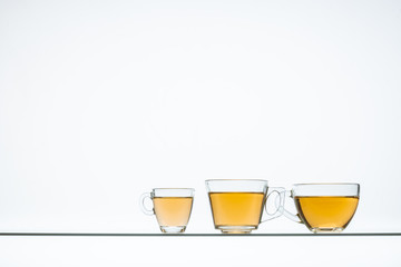 glass cups with hot tea on table, close view    