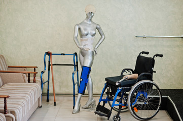 Wheelchair and mannequin at prosthetist clinic.