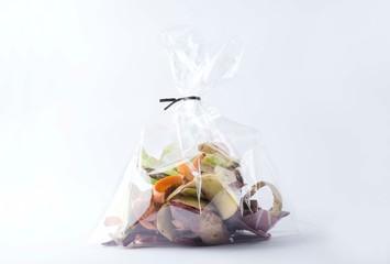 Fototapeta na wymiar Packaging of organic vegetable peelings to compost.Eco bags, biodegradable concept