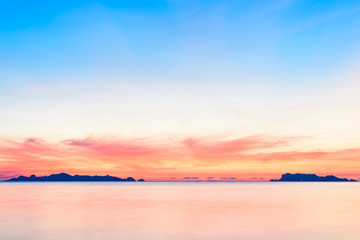 Beautiful beach sunset with blue sea and golden light sky  cloud background,long exposure technique