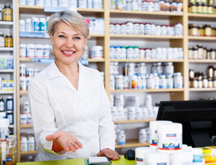 Aged female seller noting assortment of care products