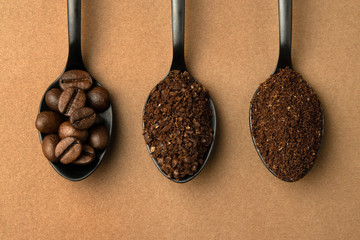 Coffee beans and different grinding coffee - coarse coffee, finely ground coffee in black spoons....