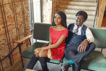 Obraz premium Black couple. Woman in a red dress. Man in a suit.