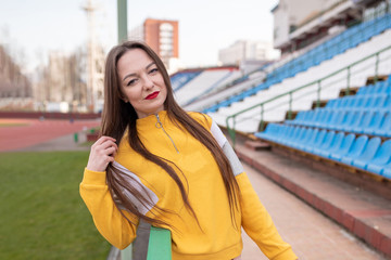 Girl alone in an empty stadium.