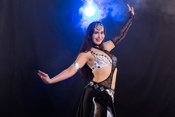 Portrait of a woman in oriental costume performing belly dance. Tribal fusion dance concept.