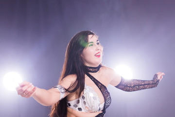 Belly dancer. Young attractive woman dancing tribal fusion on the stage. Oriental exotic dance.