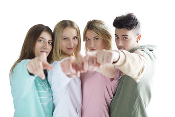 Young people pointing at you standing together