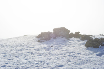 snow covered rocks in winter