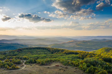 Beautiful sunset over autumnal landscape seen from a drone. Wanderlust concept. 