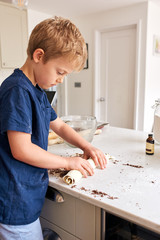 Young boy baking in kitchen