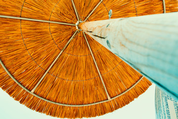 Rustic Wooden Beach Umbrella on a Clear Blue Sky