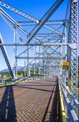 Silver truss transport metal bridge over the Columbia River connects the two states of Oregon and Washington to Columbia Gorge national reserve