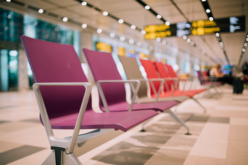 Fototapeta premium Singapore - June 1st 2019: Empty seats at the departure gates for international flights at the Changi International Airport.
