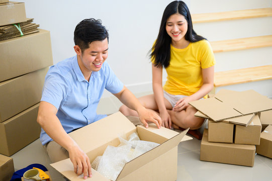 Thai Entrepreneur Couple Are Packing The Box. Selling Online And Home Delivery. Teamwork For Startup SME Business And Work From Home Concept. Social Distancing And Physical Distancing.