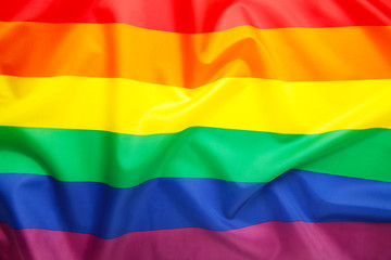 A rainbow flag background with copy space.