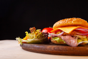 fresh hamburger with cheese meat greens and tomato
