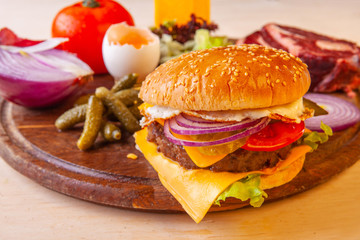 fresh hamburger with cheese meat greens and tomato