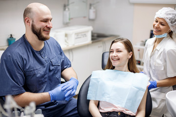 Obraz premium Young woman patient waiting treatment in stomatology clinic.