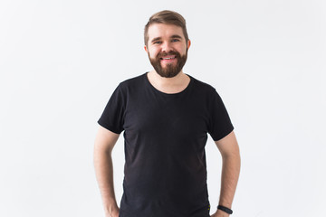 Obraz premium Cheerful guy smiled happily, has excited expression over white studio background. Holidays, youth, emotions concept.