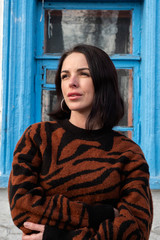 woman on the background of the window. brunette outside a residential building