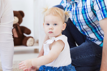 Fototapeta premium Hearing aid in baby girl's ear. Toddler child wearing a hearing aid at home. Disabled child, disability and deafness concept.