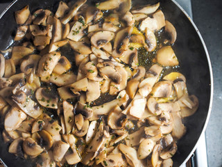 Cooking fresh mashooms, flat lay view. Roasting sliced champignons
