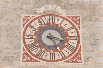 The clock painted and recently restored outside the bell tower of the church in Tiso.