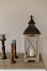 Interior accessories. Wooden lantern and candleholders. Negative space.