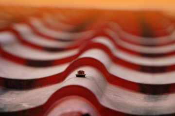 Red screws and red roof tiles for industrial and construction buildings.
